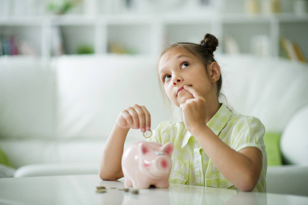 beautiful girl with a piggy bank - 写真・画像