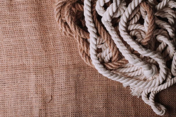 twisted ropes on burlap cloth - Foto, Imagen