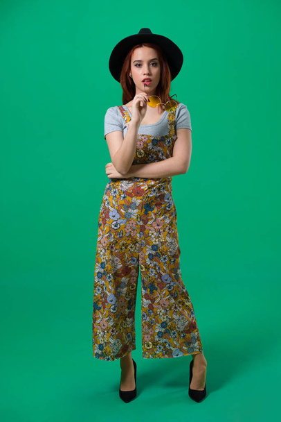 Young redhead girl posing in studio - Фото, изображение
