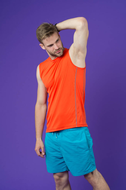 Man confident in his antiperspirant. Guy checks dry armpit satisfied with healthy skin. Prevent, reduce perspiration. No sweat - deodorant works. Sportsman after training pleased with antiperspirant - Fotografie, Obrázek