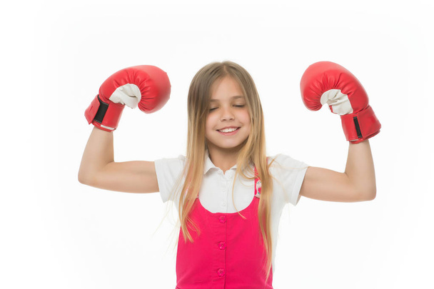 Winner takes it all Child ambitious likes win and success. Girl on smiling face posing with boxing gloves as winner, isolated white background. Kid long hair celebrates victory. Girls power concept - Foto, imagen