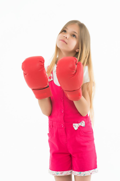 Cute boxer. Child dreams power and victory. Girl on dreamy calm face posing with boxing gloves, isolated white background. Kid long hair dreaming to be strong and independent. Independence concept - Photo, image