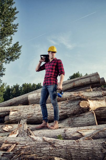 Lumberjack worker sitting in the forest - 写真・画像