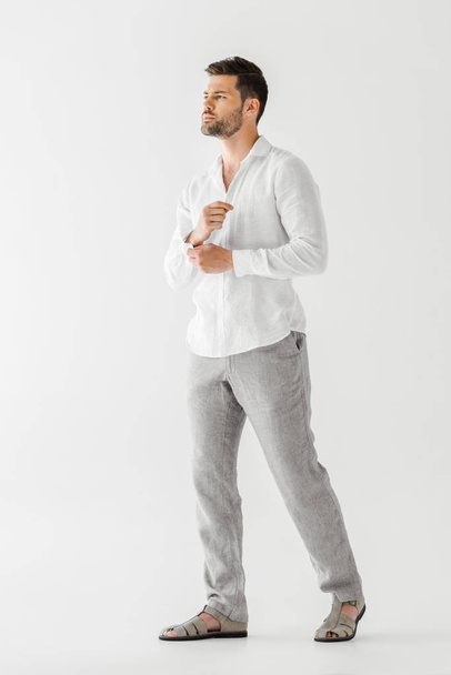 young man in linen clothes posing isolated on grey background  - Foto, Bild