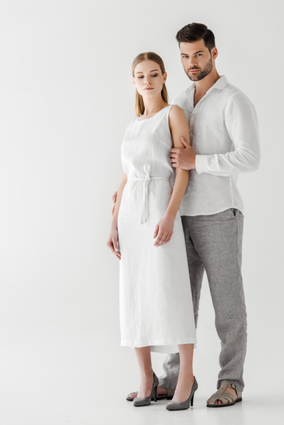 young couple in linen clothes posing isolated on grey background - Fotó, kép