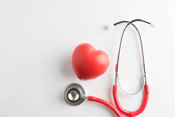 red heart and a stethoscope isolated on white background - 写真・画像