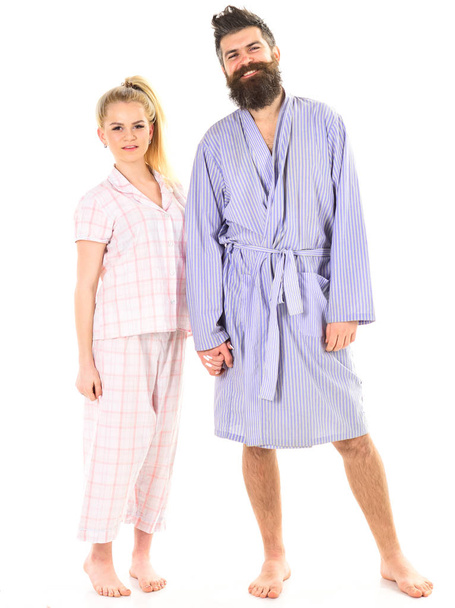 Couple hold hands together, isolated on white background. Couple in love in pajama, bathrobe. Couple, family on smiling faces in clothes for sleep looks sleepy in morning. Good morning concept - Fotó, kép