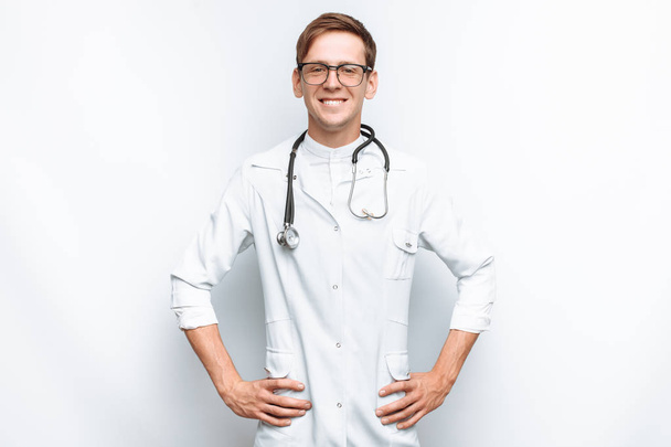 Portrait of a young doctor on a white background, Intern in the Studio - Photo, Image