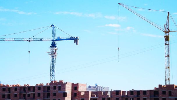 Construction site.Crane on the background of the blue sky. - Photo, Image