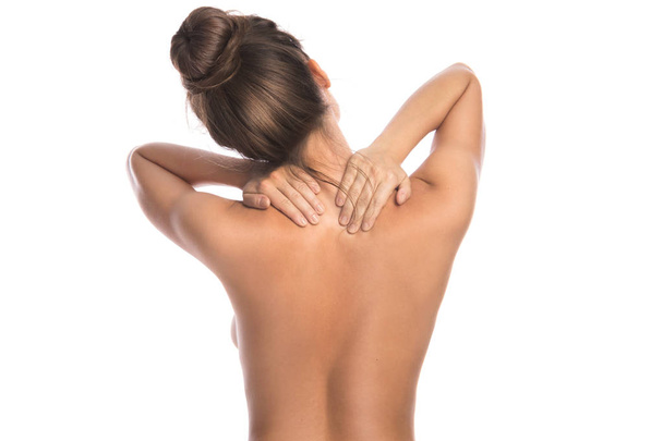 Woman with pain in back and neck on white background - Foto, Imagen