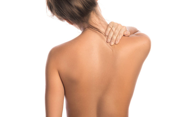 Woman with pain in back and neck on white background - Foto, immagini