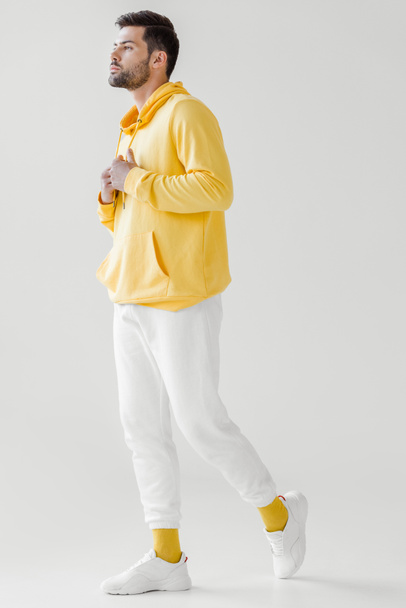 stylish young man in yellow hoodie on white - Photo, Image
