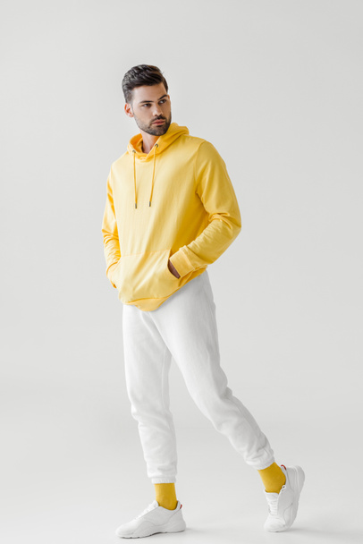 handsome young man in yellow hoodie posing on white - Photo, image