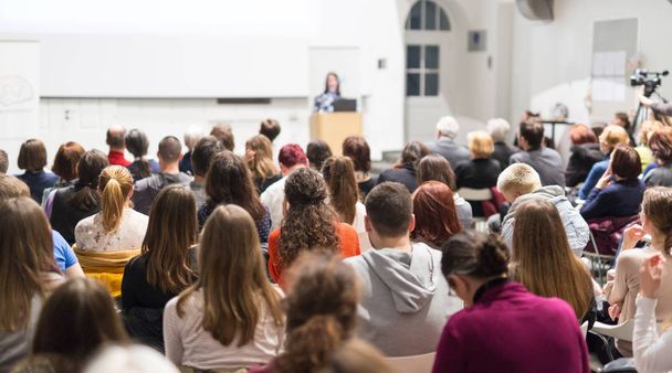 Woman giving presentation in lecture hall at university. - Photo, Image