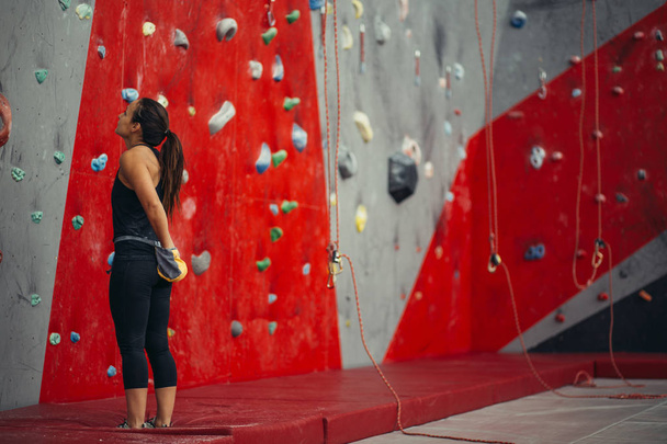 Rear view of sportswoman looking at climbing wall - Φωτογραφία, εικόνα