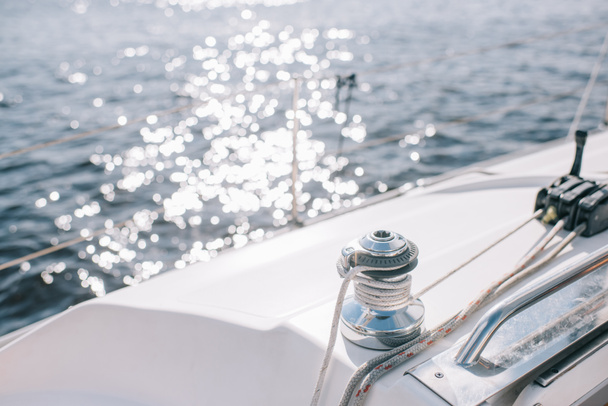 selective focus of yacht and sun glares on water surface - Photo, Image