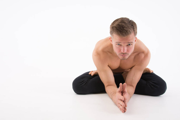 Young handsome man and yoga. Training and relaxation.  Healthy lifestyle - Foto, immagini