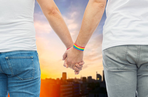 male couple with gay pride rainbow wristbands - Fotó, kép