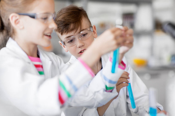 kids with test tubes studying chemistry at school - Фото, изображение