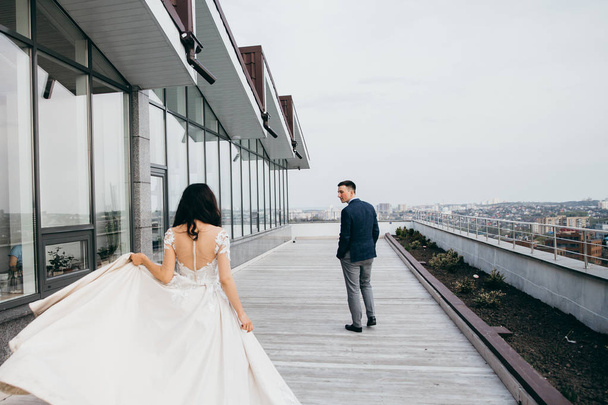 beautiful  young couple of newlyweds on roof - Foto, Imagen