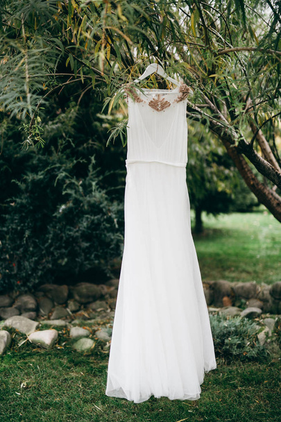 white Wedding dress in the morning hanging  - Φωτογραφία, εικόνα