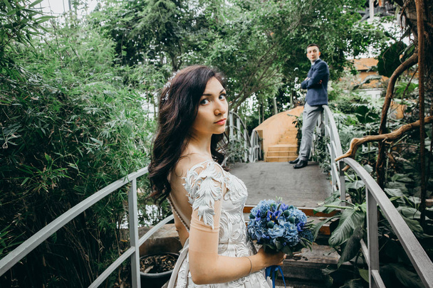 beautiful  young couple of newlyweds    in botanic garden  - Foto, Imagem