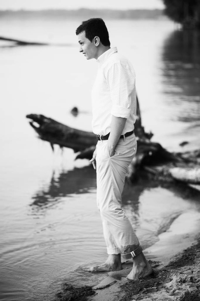 handsome  young man  posing on  beach - 写真・画像
