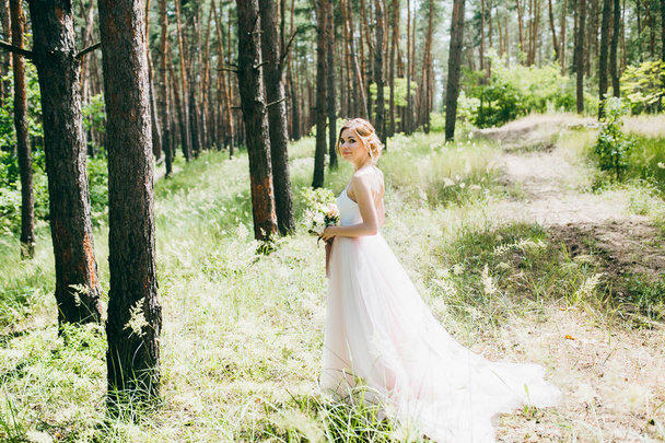 Delicate beautiful  bride in the forest - Фото, зображення