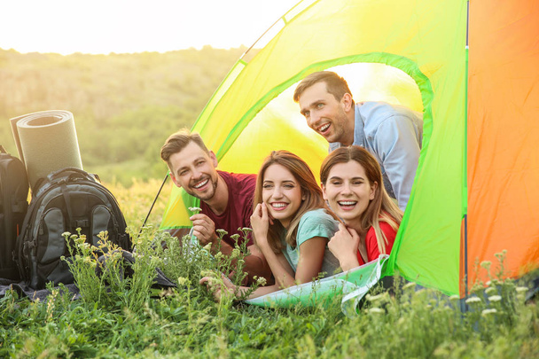 Group of happy young people in camping tent - Фото, зображення