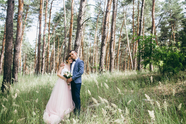 happy couple of young  newlyweds in forest - Photo, image