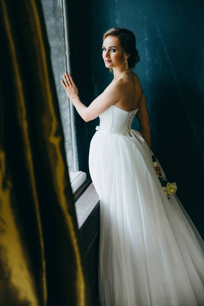 young  beautiful  bride posing by window  - 写真・画像
