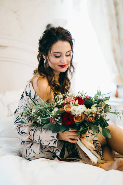 young  beautiful  woman with flowers on bed  - Photo, image