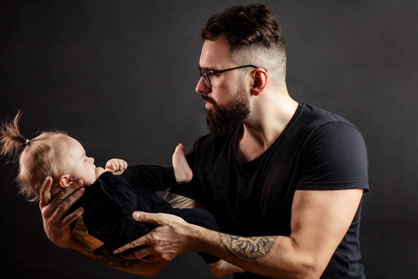handsome father holding his cute newborn baby - Photo, image