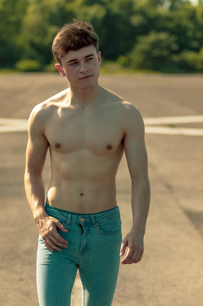 Young adult male walking forward shirtless on a warm summer's day - Photo, image