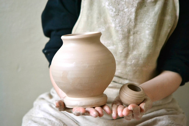 Potter holds made pots - Photo, Image