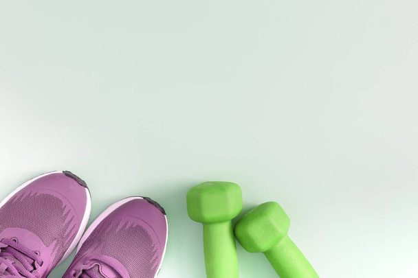 Violet sneakers and green dumbbells. Fitness background with place for text. Mock up. Photo from the top. - Photo, Image