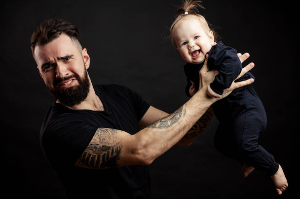 portrait of father holding on air his adorable child - Фото, изображение