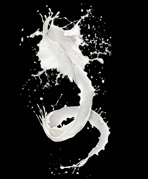 Abstract splash of milk isolated on black background - Фото, изображение