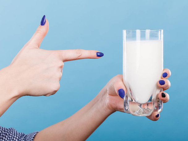 Healthy drinks, good nutrition, dairy products concept. Woman hand holding glass of milk - Photo, Image