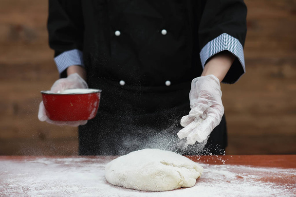 кухар робить борошно для випічки на столі
 - Фото, зображення