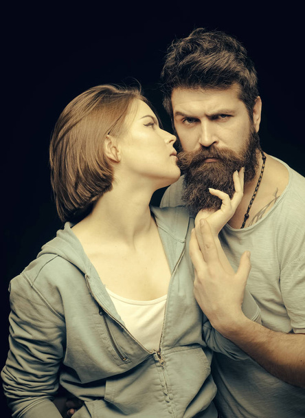 Man with stylish beard. Fashion shot of couple after haircut. Barbershop concept. Woman on mysterious face with bearded man, black background. Man with stylish beard and mustache and girl with fresh - Photo, Image
