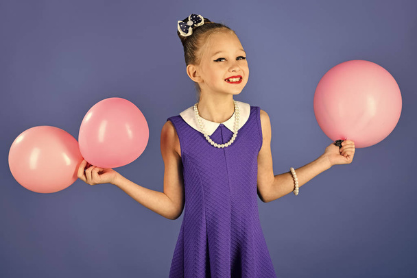 Kid with balloons at birthday. L Beauty and fashion, punchy pastels. Small girl child with party balloons, celebration. Birthday, happiness, childhood, look. ittle girl with hairstyle hold balloons - 写真・画像