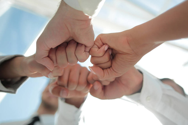 Close up .businessman and businesswoman making a fist bump on building background - Foto, afbeelding