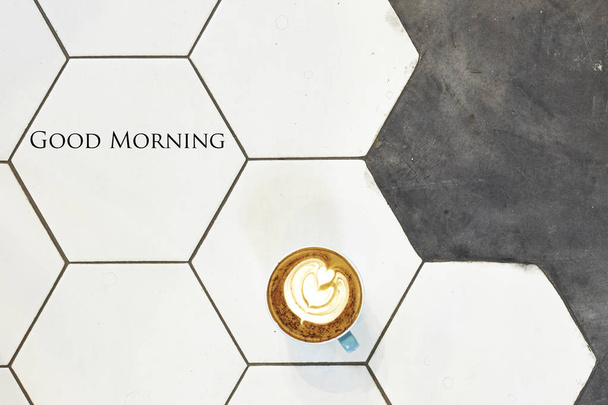 Hot fresh latte coffee cup on white ceramic tiles overhead view.Flat lay.Top view with copy space,good morning - Photo, Image
