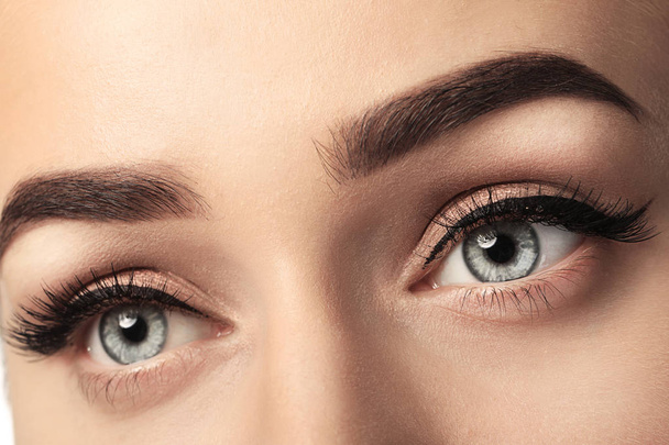 Young woman with beautiful eyebrows after correction, closeup - Foto, Bild