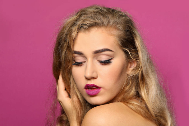 Young woman with beautiful eyebrows on color background - Fotó, kép