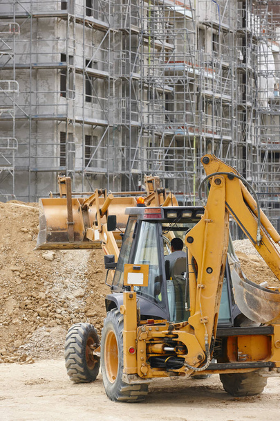 Excavator on a construction site. Building in progress. Architecture. Vertical - Foto, Imagem