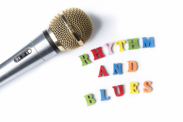 Microphone on a white background with the words the RHYTHM and BLUES of multi-colored letters. - Photo, Image