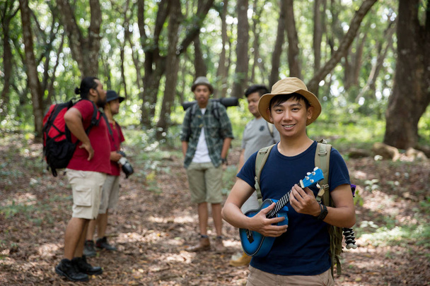 male with ukulele hiking to the forest - Photo, Image