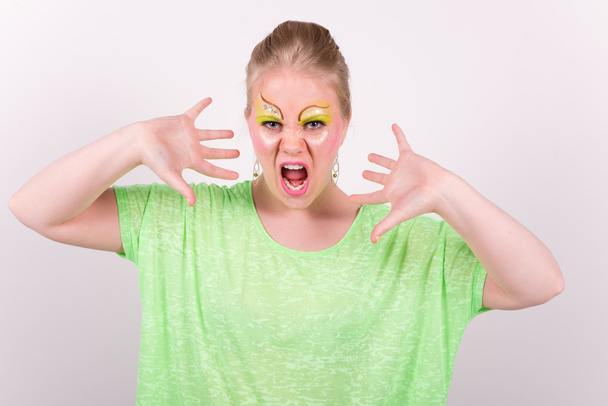 beautiful screaming young woman with green makeup - Photo, Image